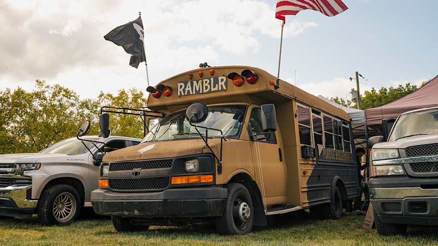 The Ramblr yellow bus lined up at a tailgate