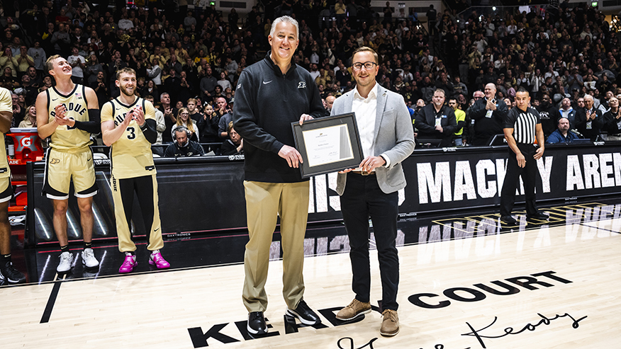 Man receiving award on basketball court