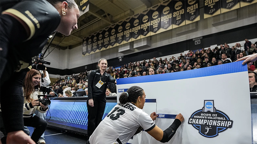 Volleyball player placing decal on bracket