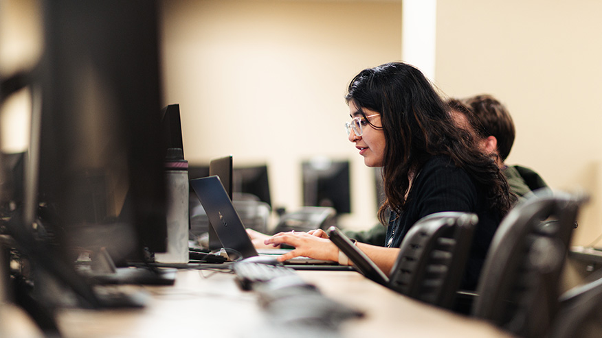 Side view of students at computer