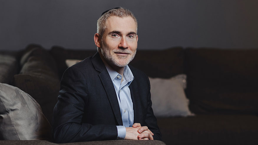 Purdue Global Law School Dean Martin Pritikin in a chair.