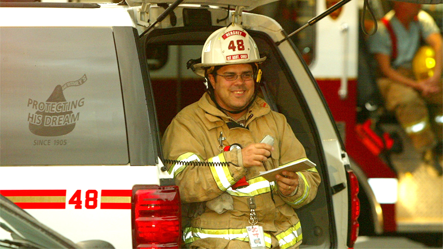 Firefighter Rodney Sonderman sits in the back of an emergency vehicle.