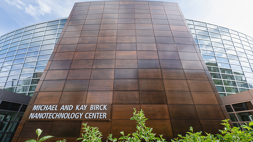 Exterior image of Purdue’s Birck Nanotechnology Center with a bush in the foreground