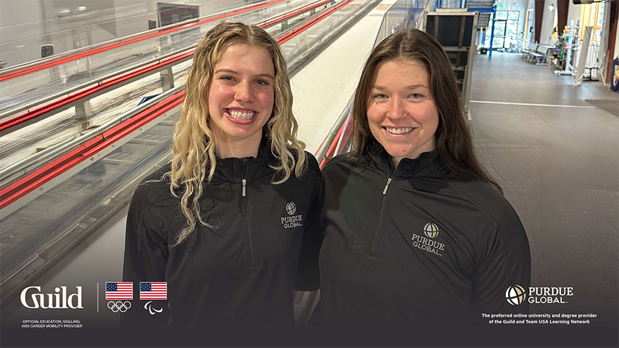 Two women standing next to each other wearing Purdue Global gear.