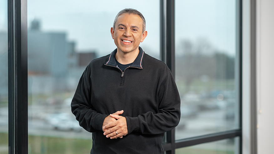 Man posing in front of window