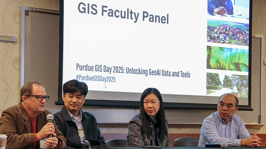 Group at panel with screen behind them