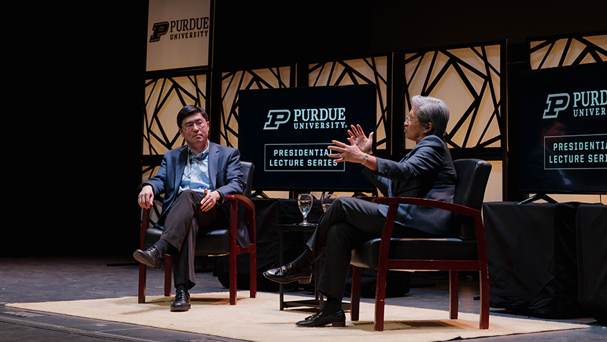 Two people sitting on stage