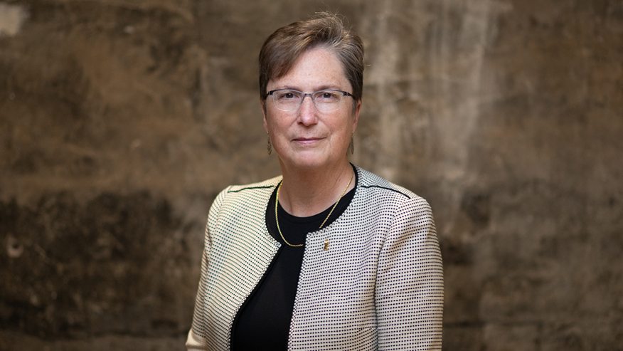 Headshot of Maj. Gen. Theresa C. Carter with a brown background.