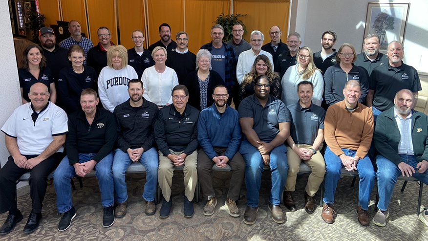 A group of people posing together for a group photo.