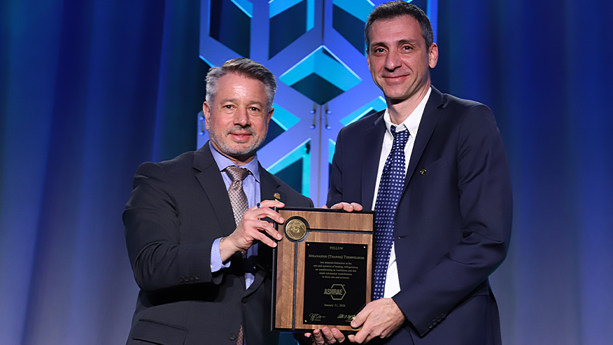 Two men holding award
