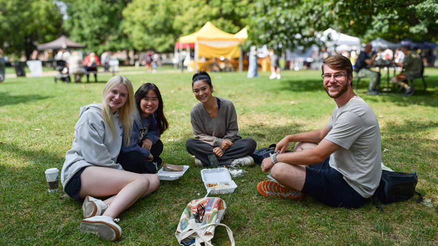 Students smiling on lawn