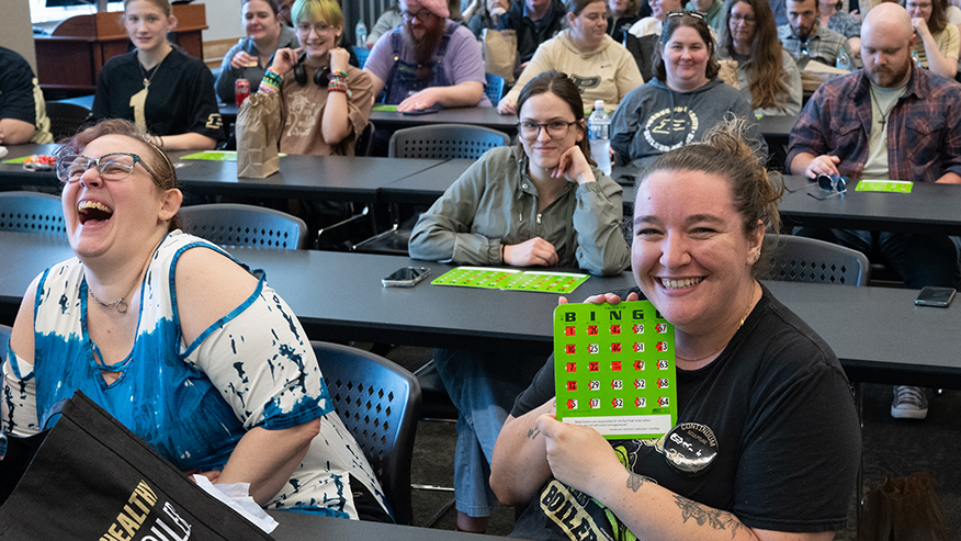 A bingo player holds up their card.