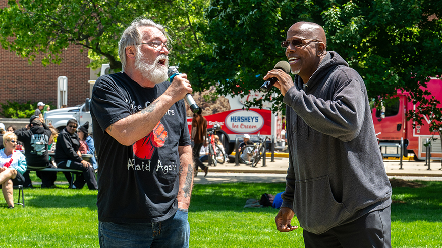 Two people singing into microphones