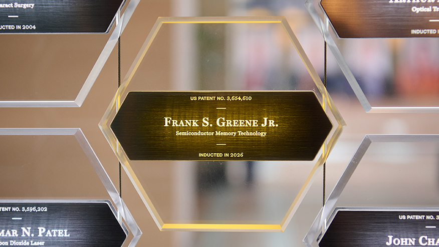 A clear hexagonal plaque with Frank S. Greene Jr.'s name, field, patent number and year of induction.