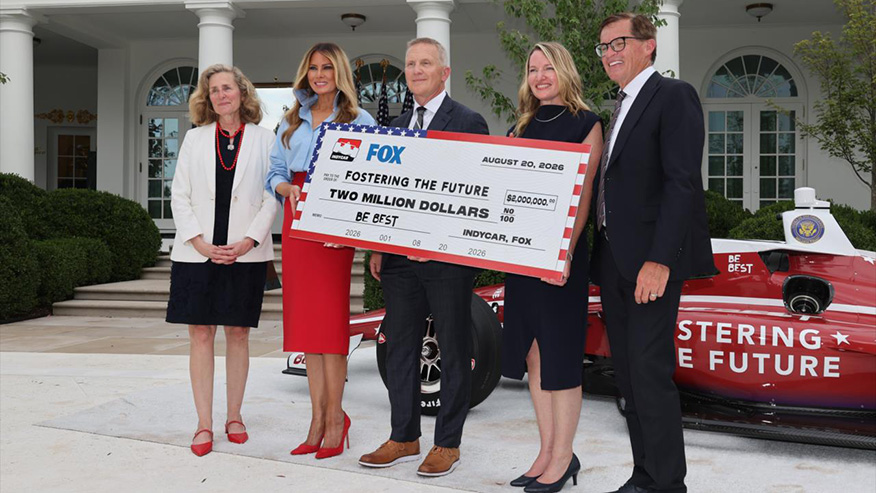 Group of people holding large check