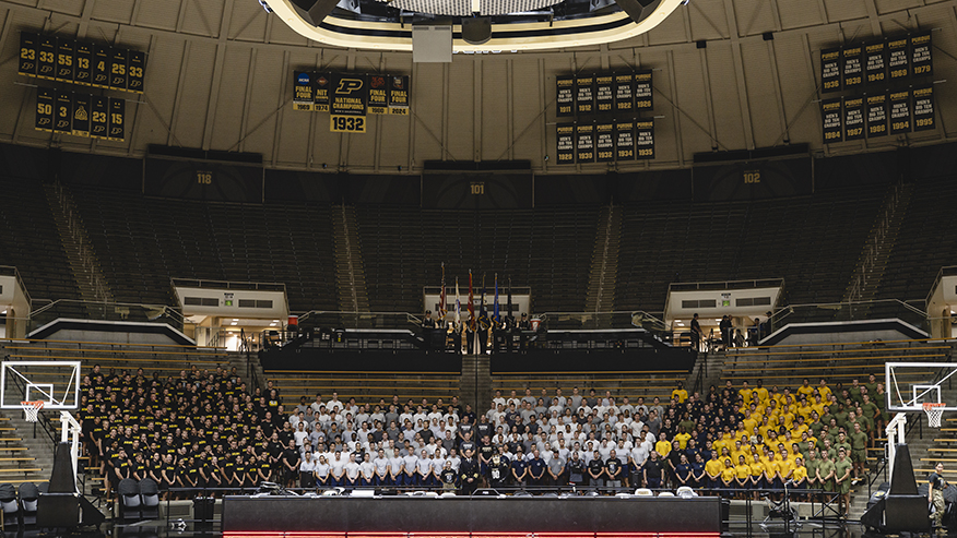 Wide shot of group seated in Mackey Arena
