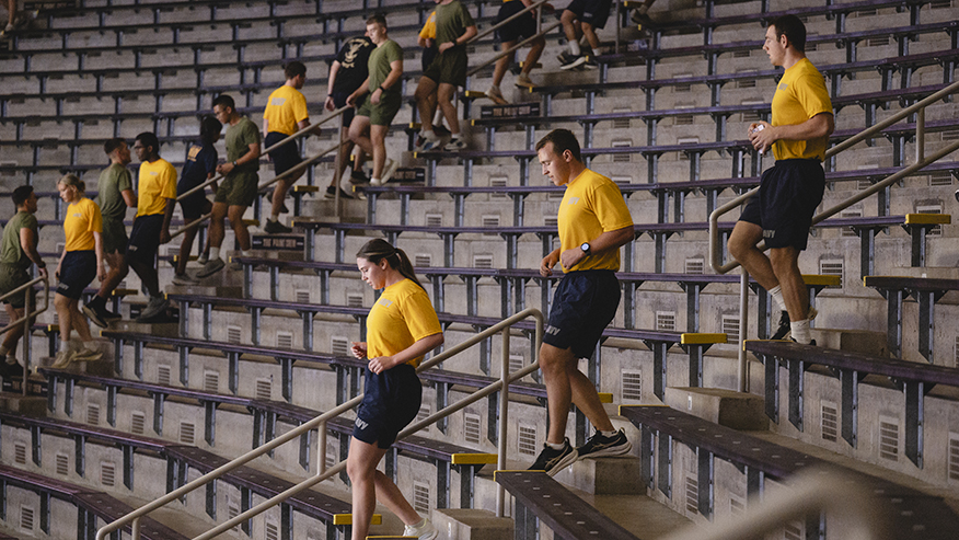 Members of Purdue ROTC go up and down stairs in athletic venue