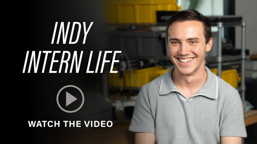 A smiling man in a gray polo shirt appears in a promotional graphic for “Indy Intern Life,” with a play button and “Watch the Video” text.