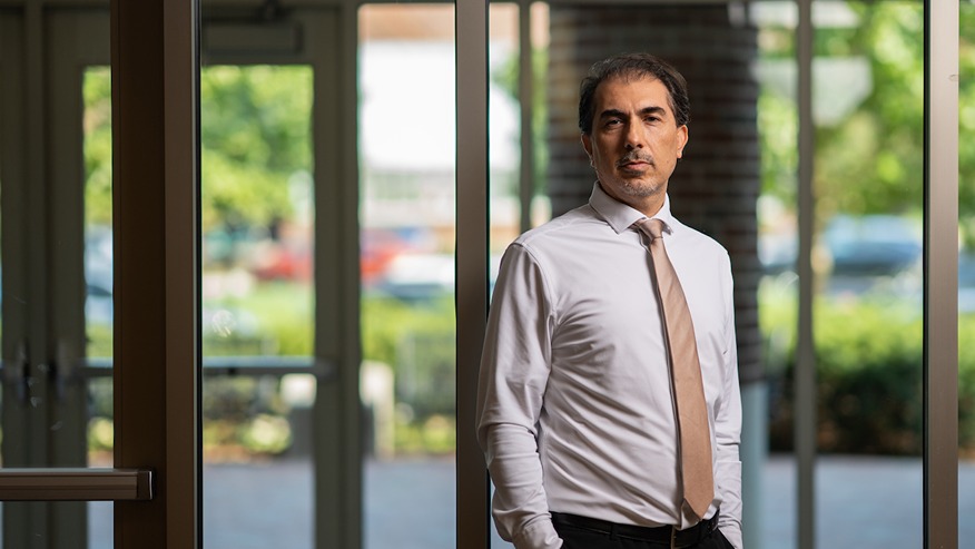 Man in front of windows showing outside