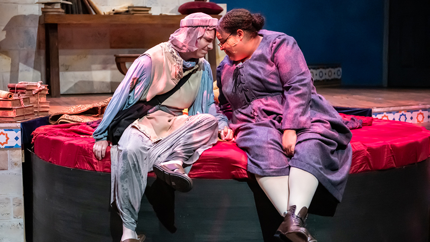 Two performers on stage during play
