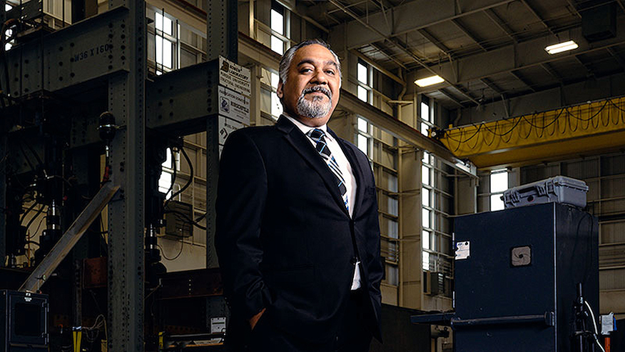 Amit Varma stands in front of equipment in Bowen Laboratory.