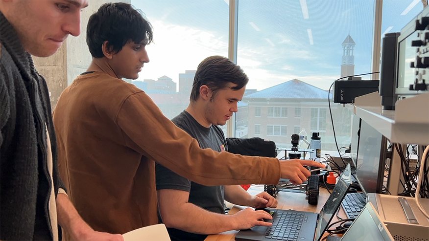 Purdue Polytechnic Institute students working together on electronics and robotics equipment in a lab space in Dudley Hall.