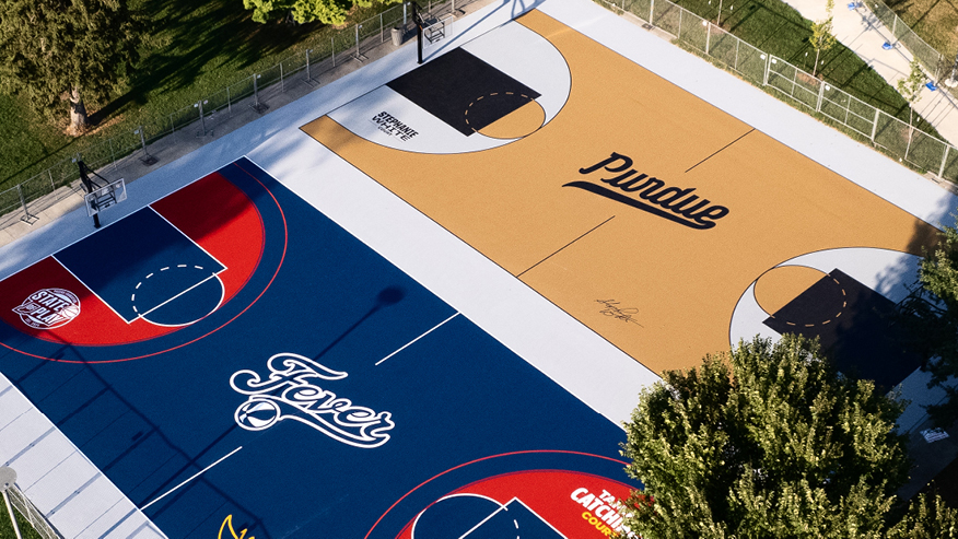 Two basketball courts, one with a Purdue theme and one with an Indiana Fever theme.