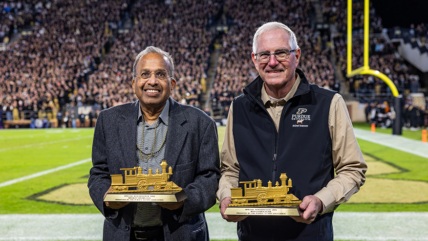 Special Boilermaker Award winners Bharat Bhargava and Ron Lemenager on the field of Ross-Ade Stadium.