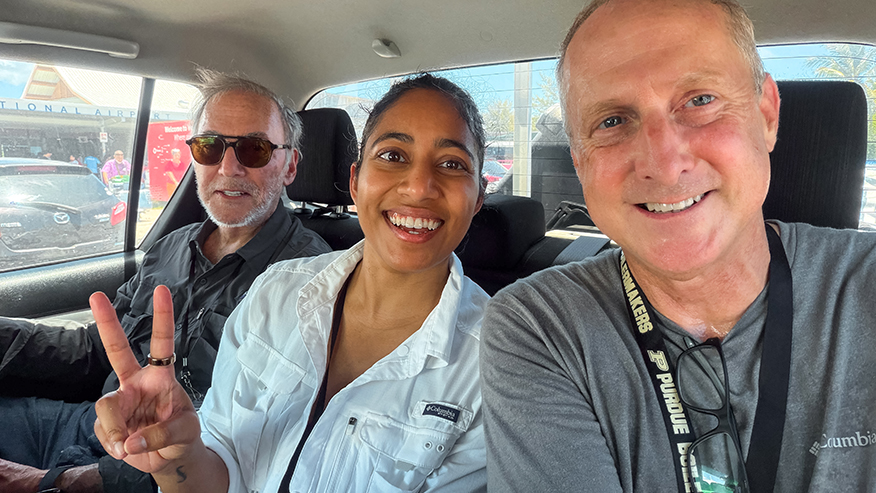 Three Purdue representatives pose together inside a vehicle during the Taraia Object expedition.