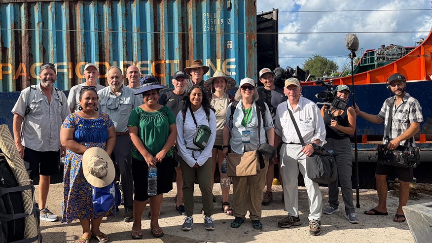 Expedition team members gather at a port before departing on a research voyage.