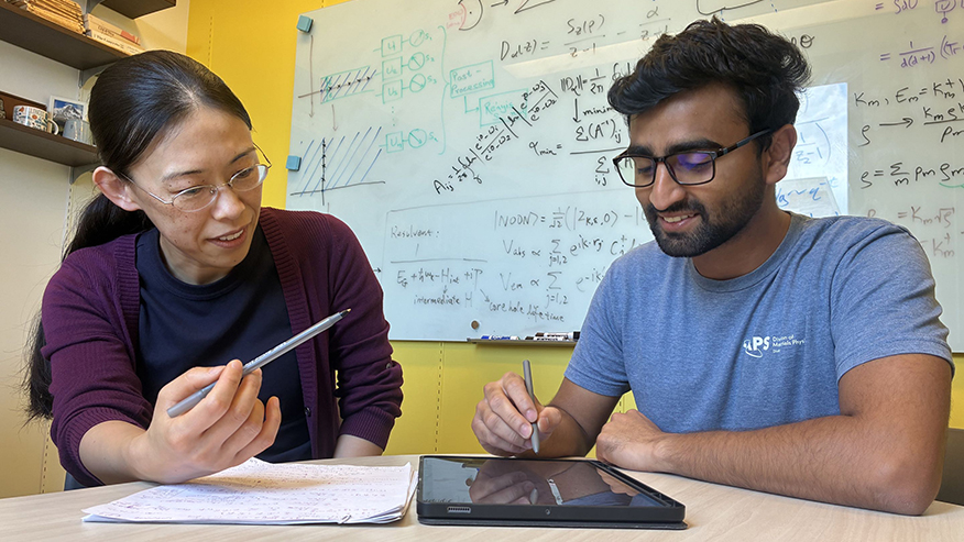 Two people looking at tablet