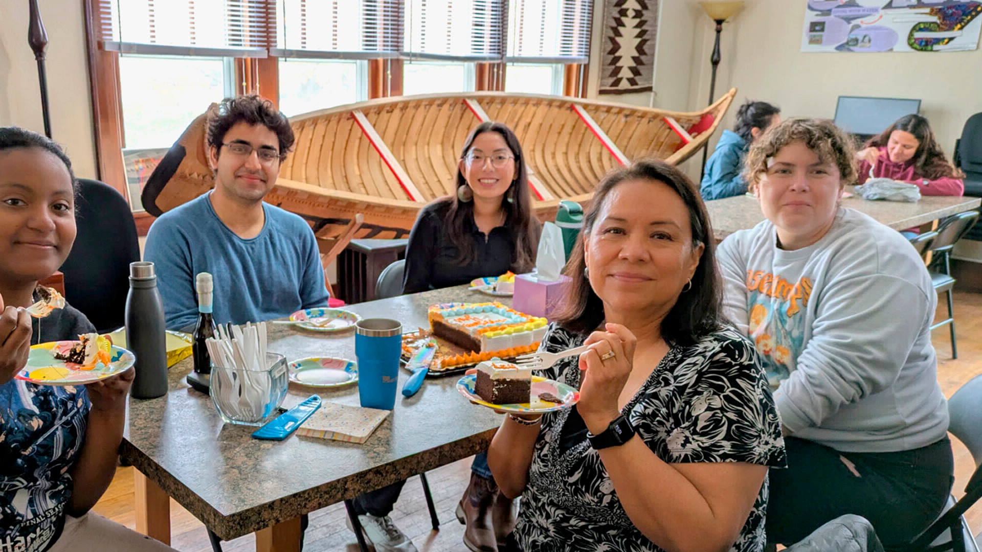 LGBTQ Callout crowd of students sitting in the grass in the green space near Wiley Dining Court.