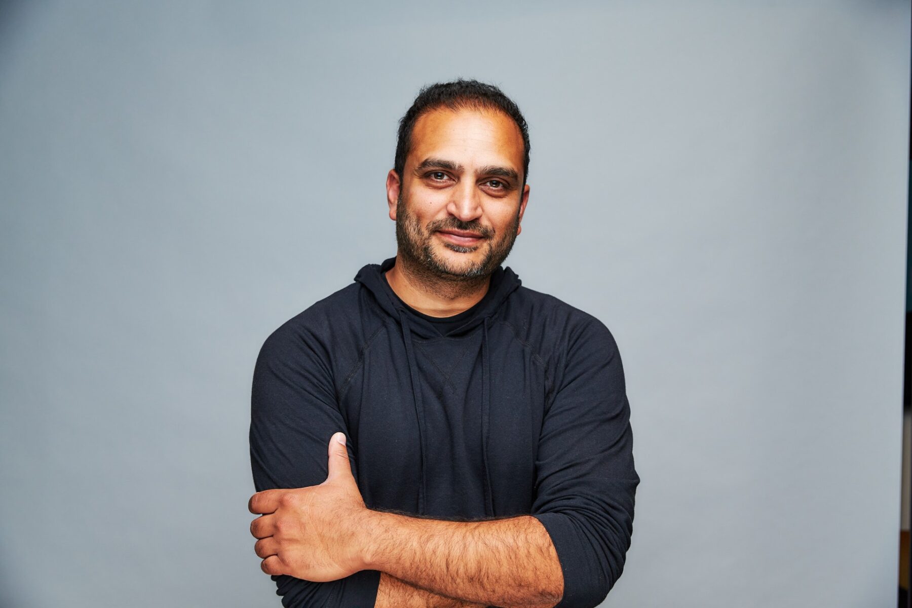 Ketal Amin standing in front of the camera wearing a black hoodie.