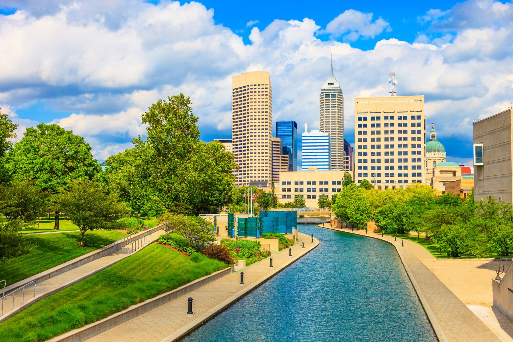 A picture of the Canal Walk in Indianapolis on a sunny summer's day, with the Indy skyline in the background.