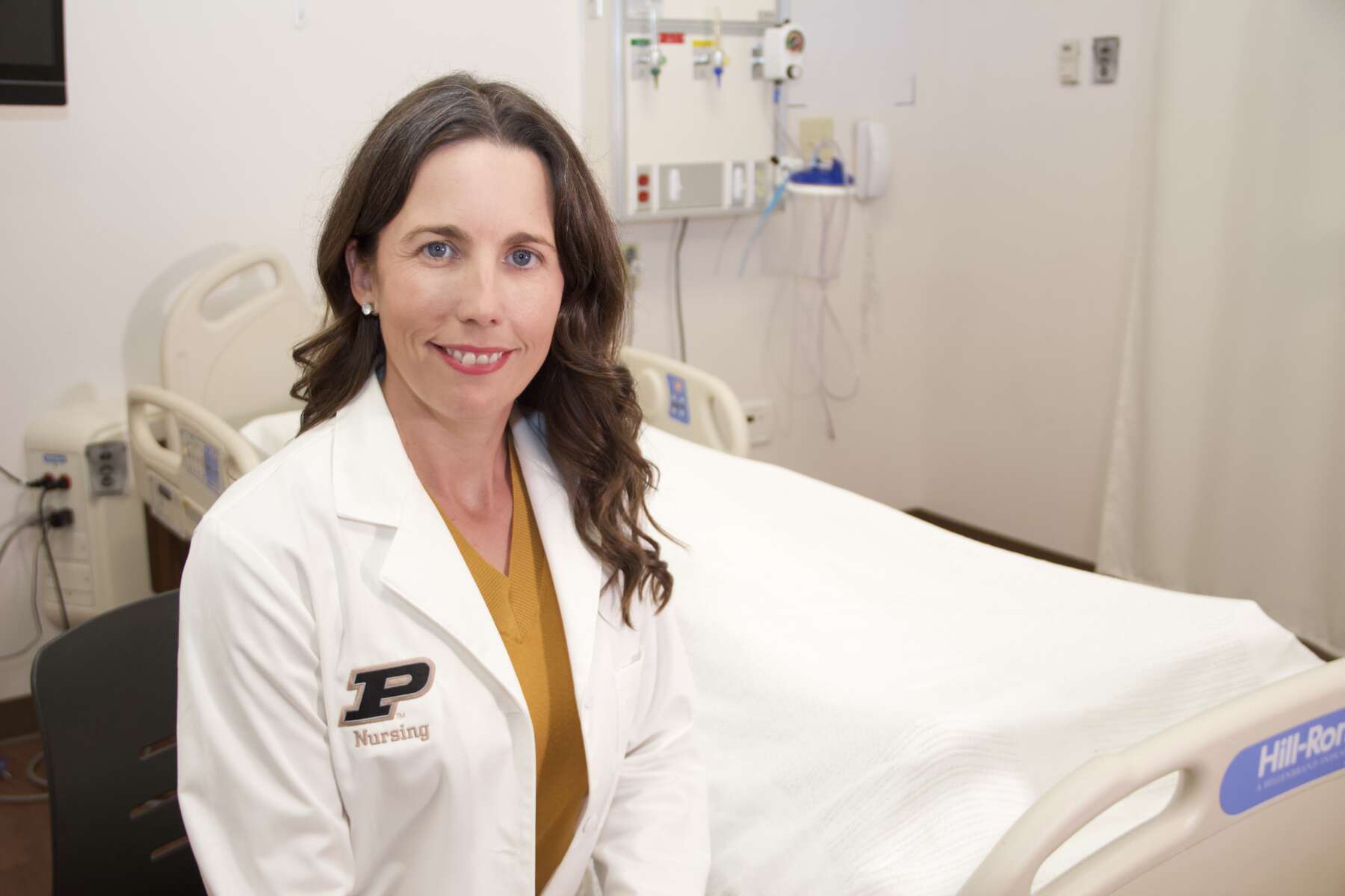 Libby Richards wearing a white medical robe with the Purdue 