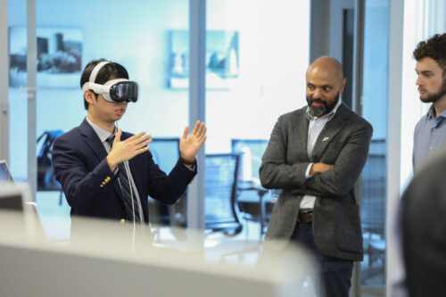 Purdue’s Marie Gordon Professor of Electrical and Computer Engineering Shreyas Sundaram and graduate student Josh Chang demonstrate how they are using Apple Vision Pro technology to integrate with an existing SWARM simulation platform, leveraging spatial computing, intuitive gesture control and real-time spatial visualization capabilities to allow operators to effectively interact with and control large robotic swarms. Purdue’s Marie Gordon Professor of Electrical and Computer Engineering Shreyas Sundaram and graduate student Josh Chang demonstrate how they are using Apple Vision Pro technology to integrate with an existing SWARM simulation platform, leveraging spatial computing, intuitive gesture control and real-time spatial visualization capabilities to allow operators to effectively interact with and control large robotic swarms.