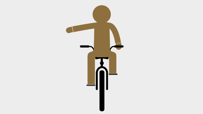 Person riding a bike holding out their left arm straight