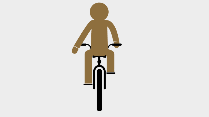 Person riding a bike holding out their left arm behind them