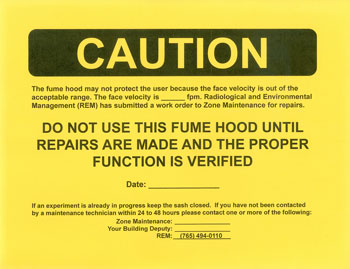 Yellow caution sign stating not to use fume hood until repaired