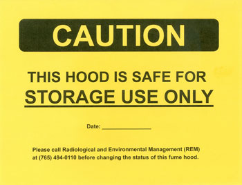 Yellow caution sign stating hood is safe for storage use only