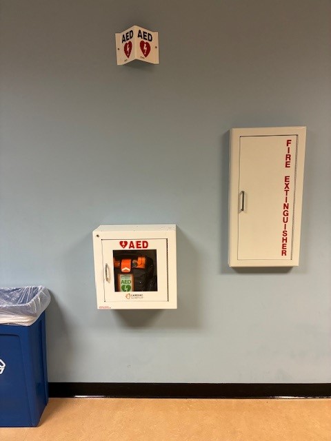 image of AED case mounted on wall across from basement elevator