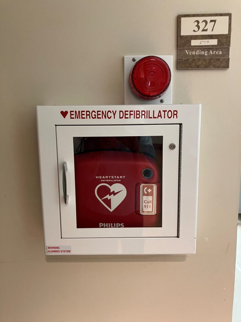 AED on wall in HOVD 327 (Vending machine room)