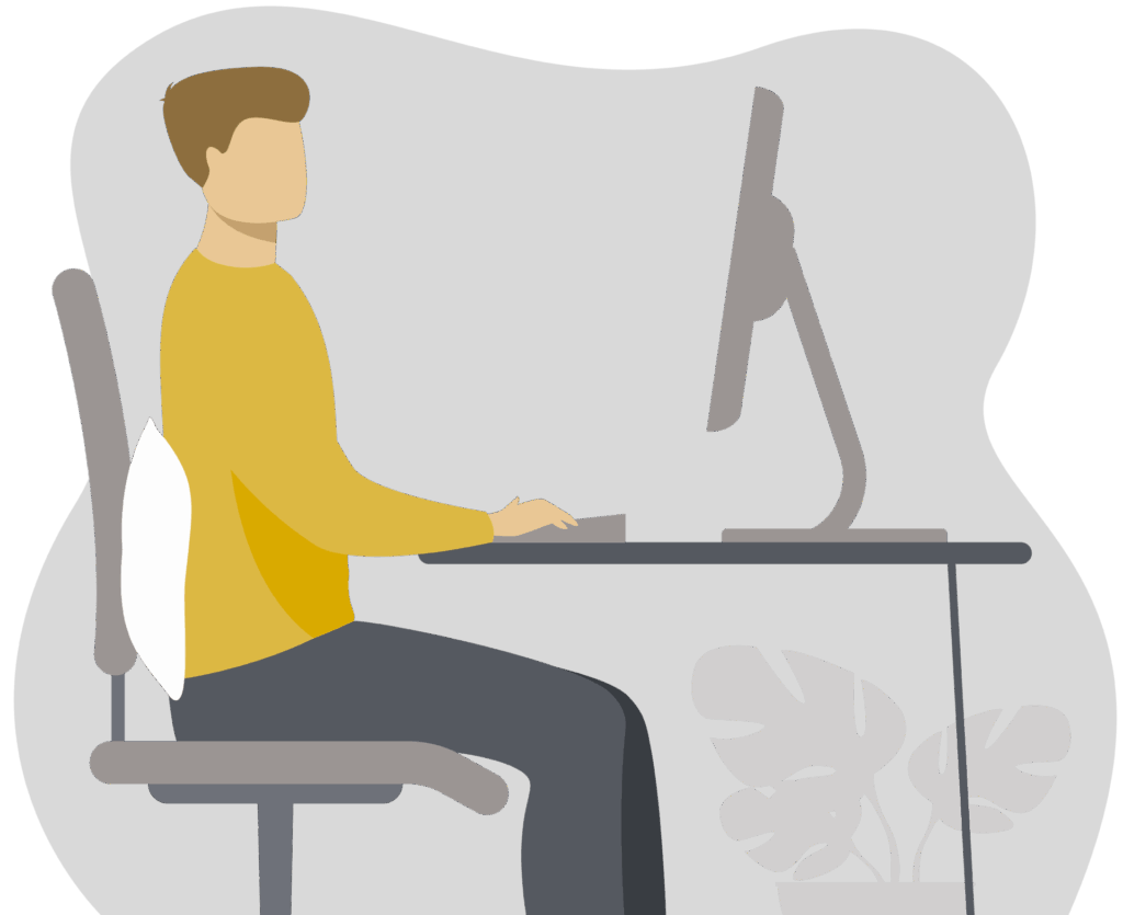 Person seated at a computer workstation using a pillow behind the lower back for lumbar support.
