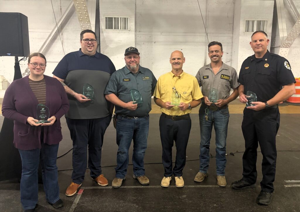 The 2026 Annual Staff Award winners pose with their awards.
