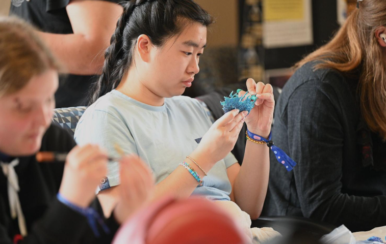 Boiler Con attendees painting miniatures.