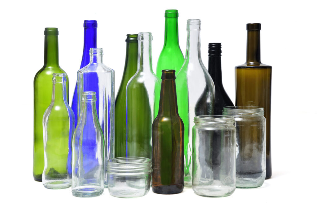 A collection of glass containers, including jars and bottles of various sizes and colors.