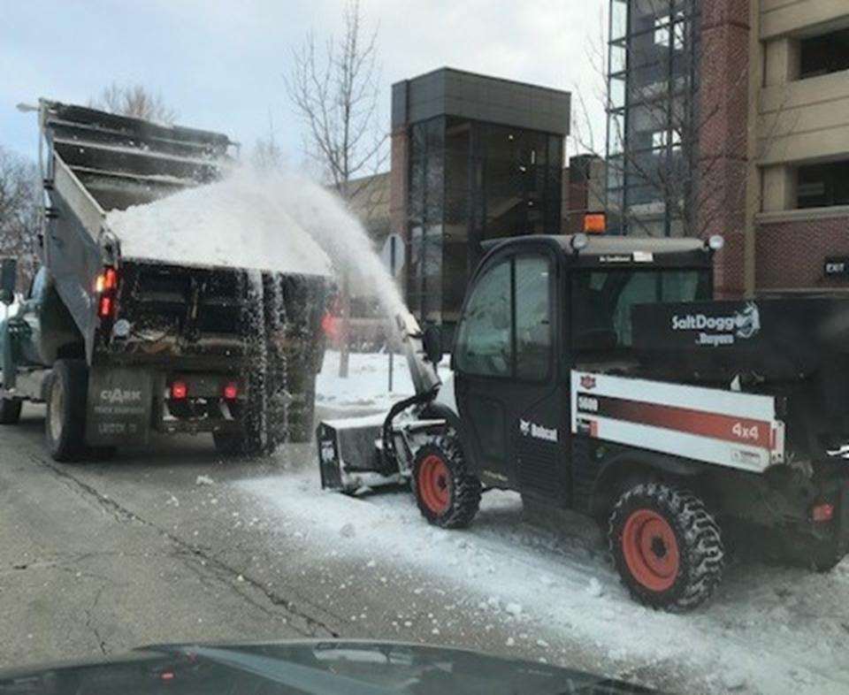 Grounds working to clear snow on campus roads.