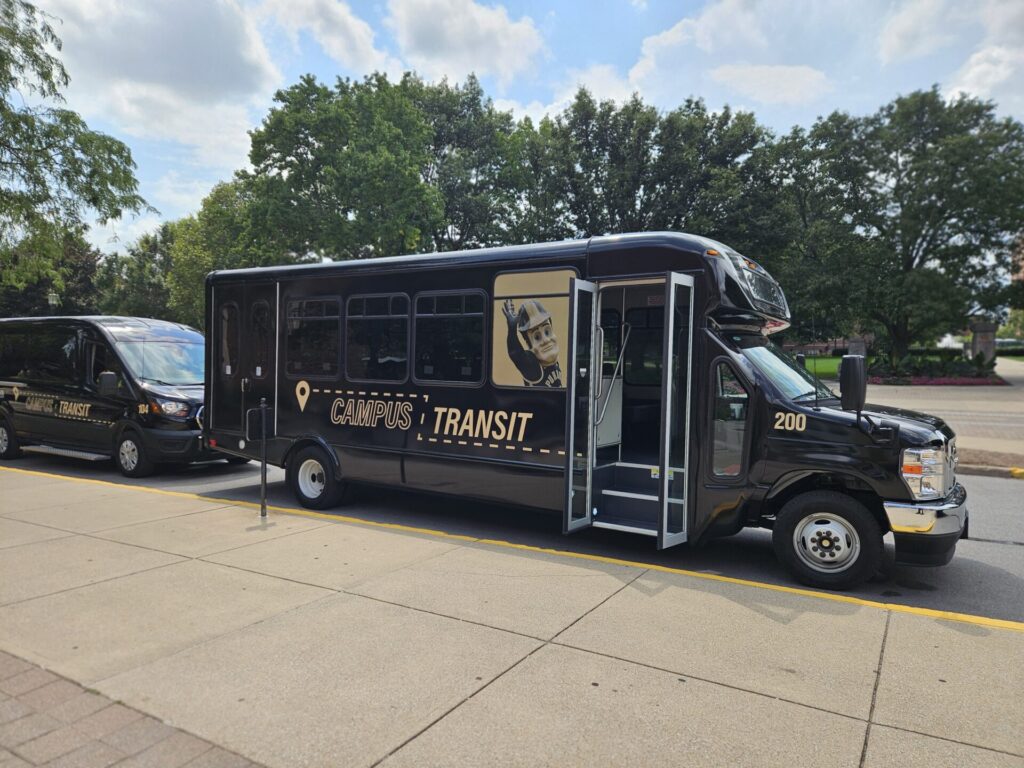 Purdue Campus Transit shuttles parked and waiting for passengers.