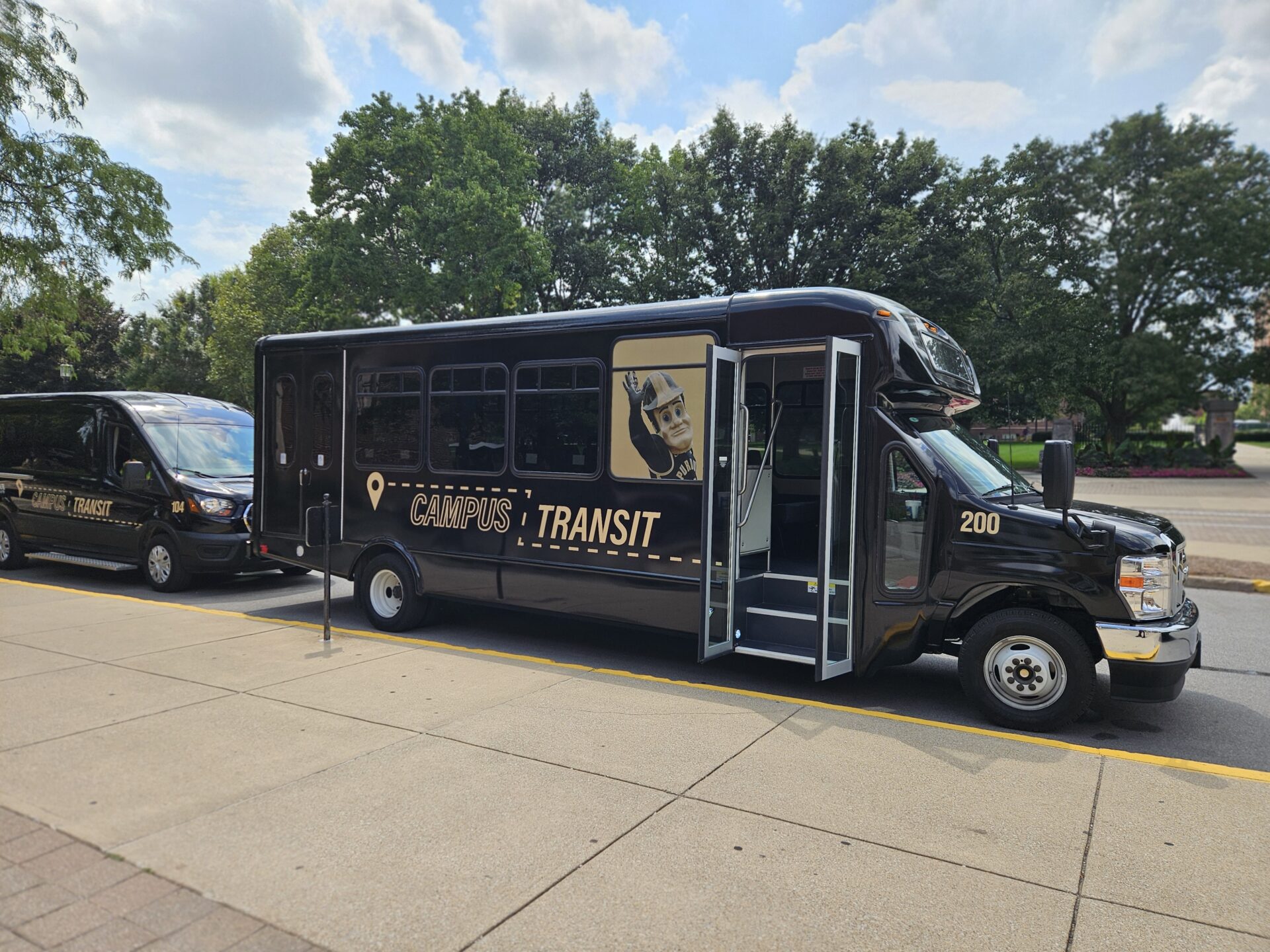Purdue Campus Transit shuttles parked and waiting for passengers.