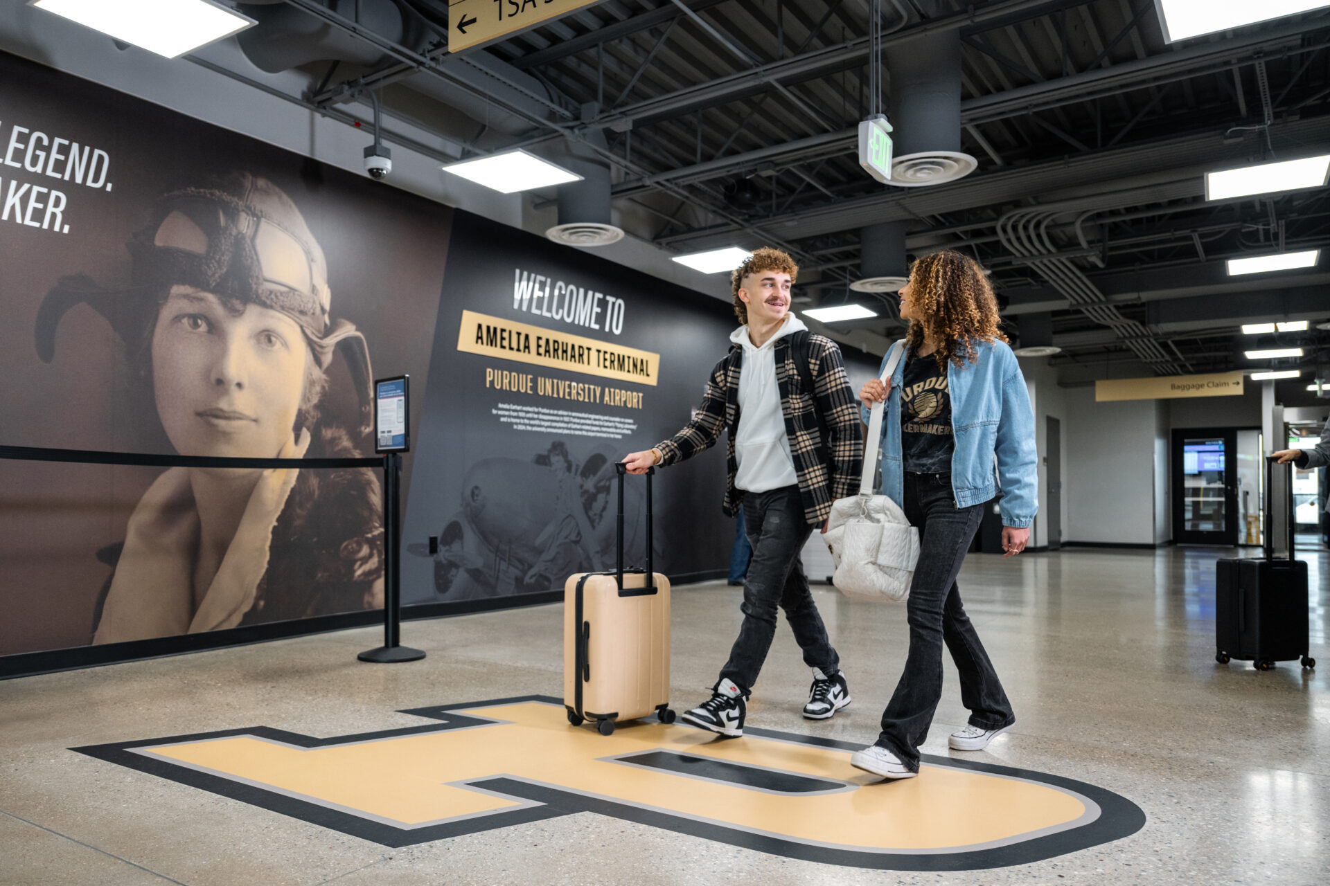 Two individuals walking through the Purdue University Airport